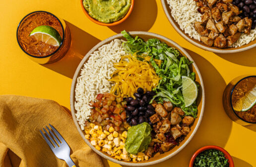 chipotle style chicken bowl on a yellow table