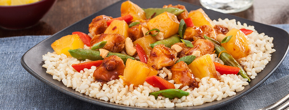 Brown rice topped with a mixture of orange glazed chicken, pineapple, green beans and red pepper