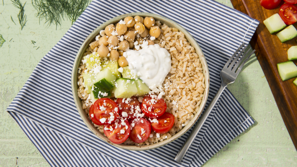 Greek-inspired rice bowl with chickpeas, brown rice, tomatoes and tzatziki sauce