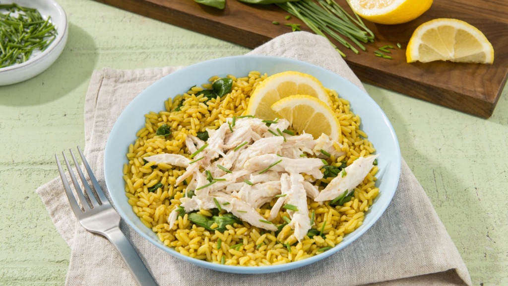 Chicken-and-rice-dish-with-artichoke-and-asiago-dip-and-lime-wedges