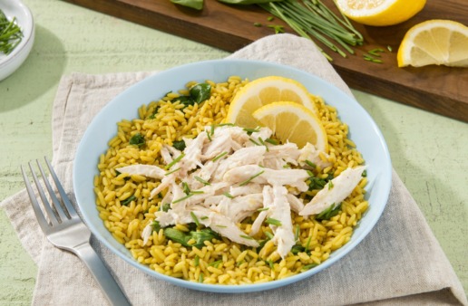 Chicken-and-rice-dish-with-artichoke-and-asiago-dip-and-lime-wedges