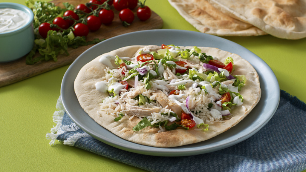 chicken-shawarma-with-jasmine-rice-served-over-a-pita-bread-with-tomatoes-and-red-onion