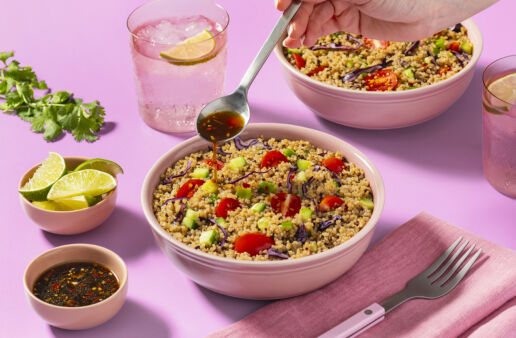 thai quinoa salad in a pink bowl on a pink table